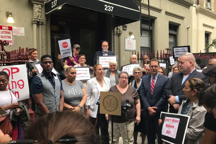 Elected officials joined community members on the Upper West Side to protest the city's decision to turn a homeless shelter for women into one for men.